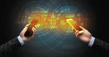 Close up of two smartphones syncing business data