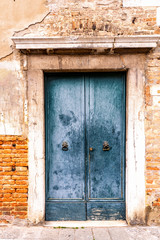 Close view of vintage door in an old wall in Venice, Italy.
