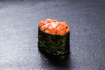 Smoked gunkanmaki maki over slate plate background © briagin