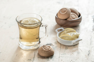 Glass of herbal tea and cookies on a wooden table