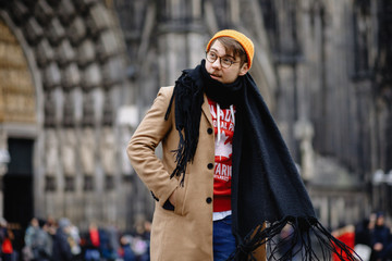 Casual style. Man stands against the sights. Cathedral Church of Saint Peter. Cologne Cathedral. Germany. Gothic architecture. 
