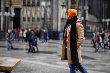 Casual style. Man stands against the sights. Cathedral Church of Saint Peter. Cologne Cathedral. Germany. Gothic architecture. 