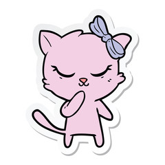 sticker of a cute cartoon cat with bow