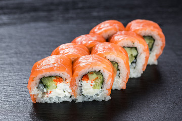 Salmon philadelphia makizushi roll arranged on stone background