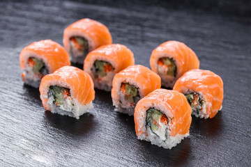 Salmon philadelphia makizushi roll arranged on stone background