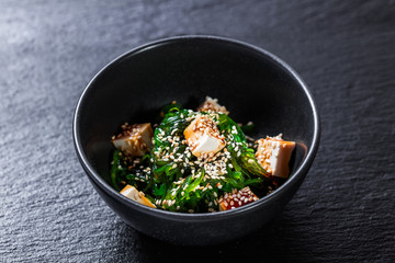 Closeup of seaweed salad with tofu seasoned with unagi sauce
