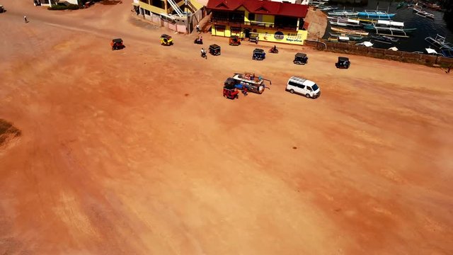 Vehicles on a Dirt Road Leading to Local Coron Island Market.