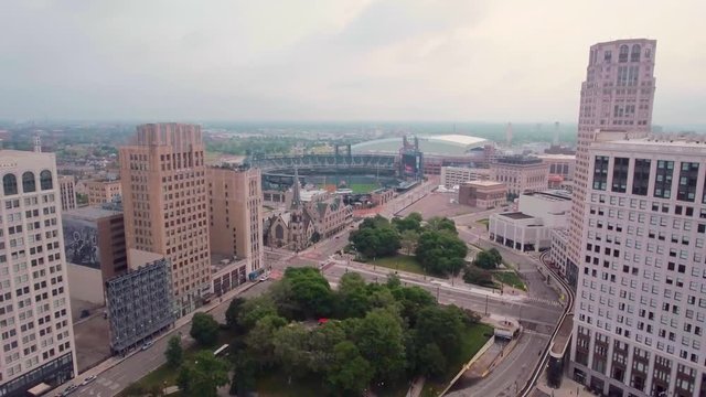 Ascending aerial shot, tilting down showing downtown Detroit.