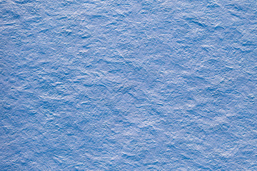 Aerial top view of abstract snow texture background with rough surface in a blue tones