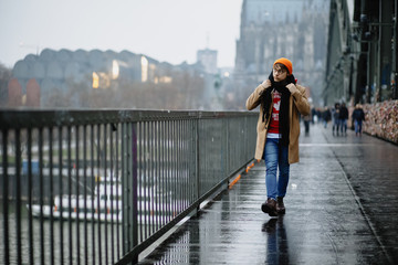 A man walks over the bridge. Cathedral Church of Saint Peter. Cologne Cathedral. Germany. Gothic architecture