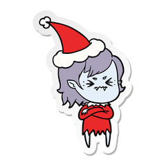 annoyed sticker cartoon of a vampire girl wearing santa hat