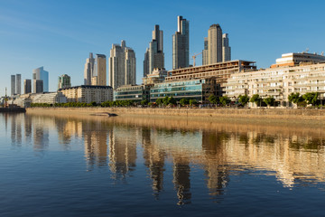 Obraz premium Sweeping view along the Rio de la Plata of the Perto Madero district of Buenos Aires, Argentina with reflections of the modern buildings in the river