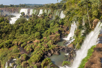 The incredible and majestic Iguazu Falls, multiple waterfalls make up this UNESCO world heritage site, seen from the Argentine side and framed by trees