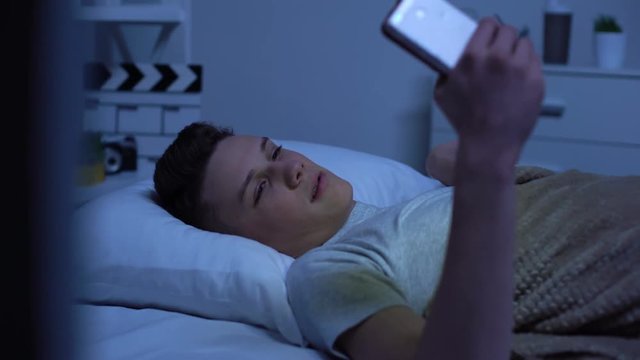 Teenager watching adult content on smartphone and masturbating, puberty age