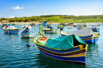 Fototapeta na wymiar Boats Luzzu at Marsaxlokk harbor