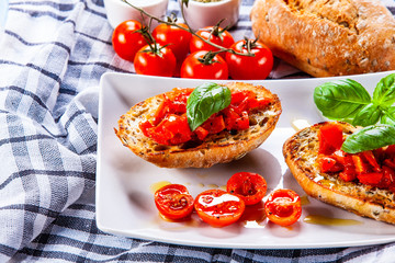 Bruschettas on cutting board on wooden background