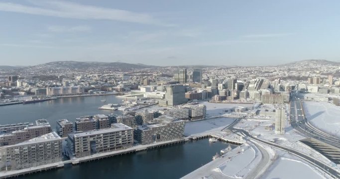 4K high angle aerial view of the beautiful Oslo skyline, The Munch Museum called Lambda and Barcode, a part of the new Bj&oslash;rvika Opera quarter, in vibrant winter sunlight.