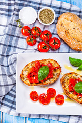Bruschettas on cutting board on wooden background