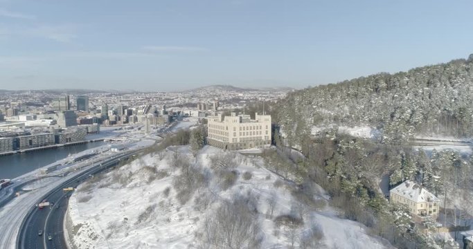 4K high angle aerial view of an old building used to train sailors with the Oslo skyline, The Munch Museum and the brand new Bj&oslash;rvika and Opera quarter, in the background.