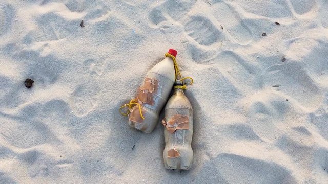 Coca Cola Coke Plastic Bottles Lying In The Sand. Environment Destruction. Climate Change. Zoom In.