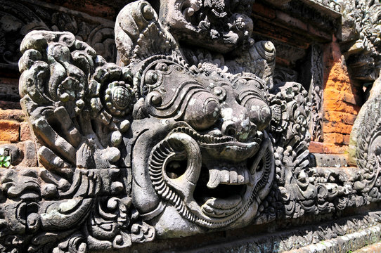 Carvings depicting demons, gods and Balinese mythological deities can be found throughout the Pura Dalem Agung Padangtegal temple in the Monkey Forest Sanctuary in Ubud, Bali, Indonesia.