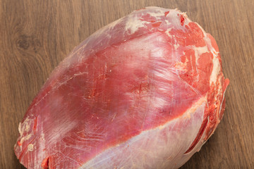 Raw fresh beef on a wooden background, catalog.