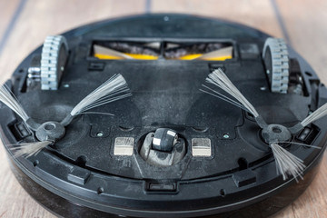 Bottom of a robot vacuum cleaner - wheels and brushes