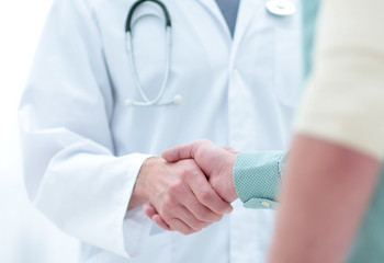 patient shakes hands with his physician