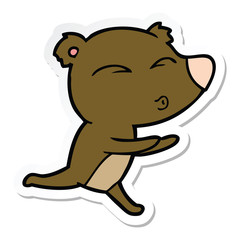 sticker of a cartoon running bear