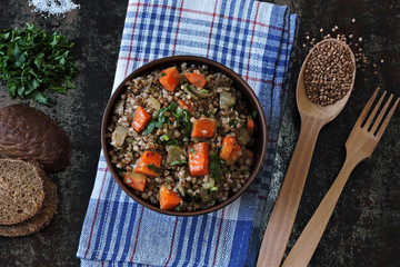 Buckwheat porridge with vegetables and herbs in a bowl. The concept of dietary nutrition. Buckwheat diet