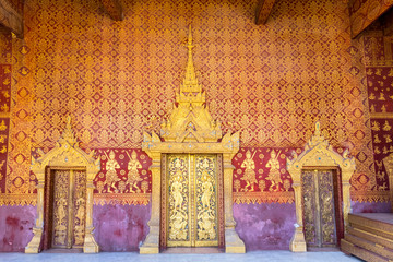 Elaborate wood carvings at Wat Saen's entrance door, Luang Prabang, Laos.