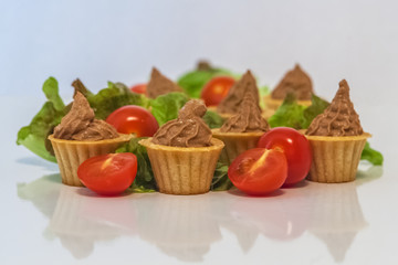 tartlets with liver pate decorated with lettuce and cherry tomatoes