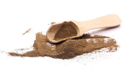 Black pepper powder with wooden spoon isolated on white background