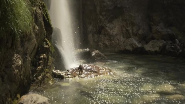 Cinematic slow motion shot (pan down) from a small waterfall in Albania.