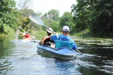 People canoe in a river
