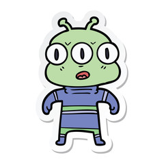 sticker of a cartoon three eyed alien