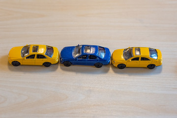 three toy cars in yellow and blue