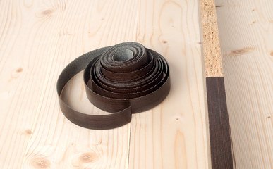 the edges of melamine chipboard on wooden background