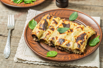 Cannelloni with minced beef and spinach baked in béchamel sauce. 