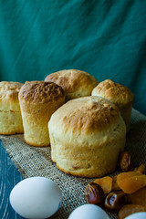 Easter cake on a dark background. Fresh cakes with dried fruits. The process of cooking Easter cake. View from the side.
