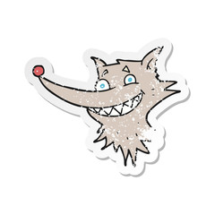 retro distressed sticker of a cartoon grinning wolf face