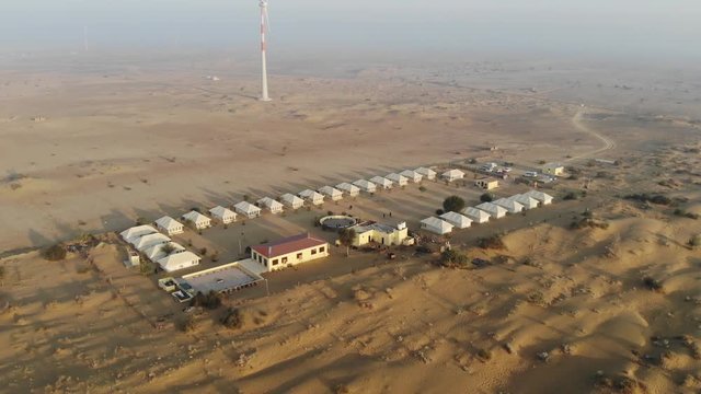 AERIAL Desert Camp tents with Wind Turbine in Desert