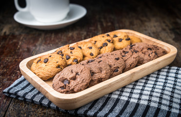 Chocolate chip cookies Closeup with cup on wooden tabel.