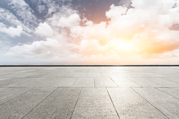 Square platform and modern city skyline with beautiful clouds at sunset