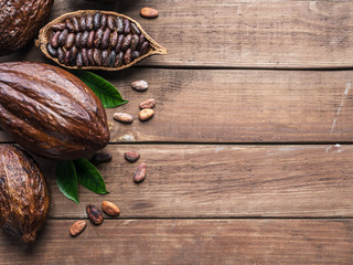 Cocoa pod and cocoa beans on the wooden table. Top view.