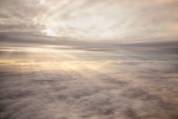 Clouds and sky as seen through window of an aircraft