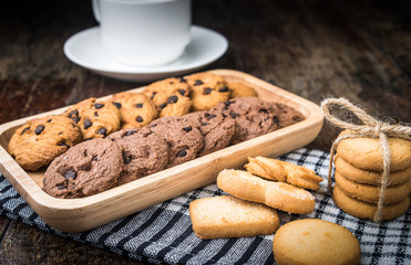 Chocolate chip cookies Closeup with cup on wooden tabel.