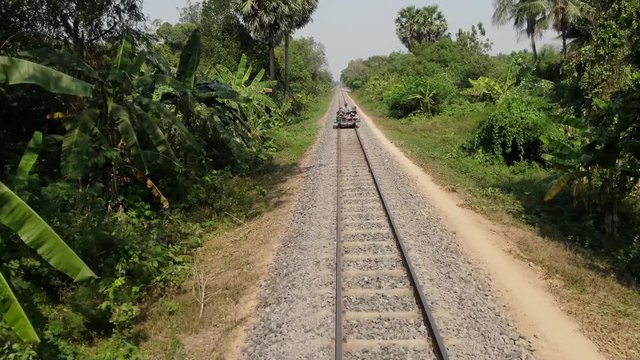 Low pullback flying aerial drone shot of bamboo train in Battambang Cambodia