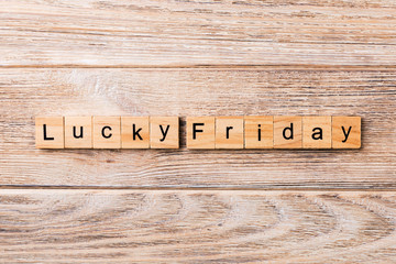 lucky friday word written on wood block. lucky friday text on wooden table for your desing, concept