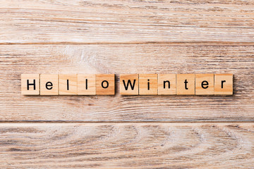 hello winter word written on wood block. hello winter text on wooden table for your desing, concept